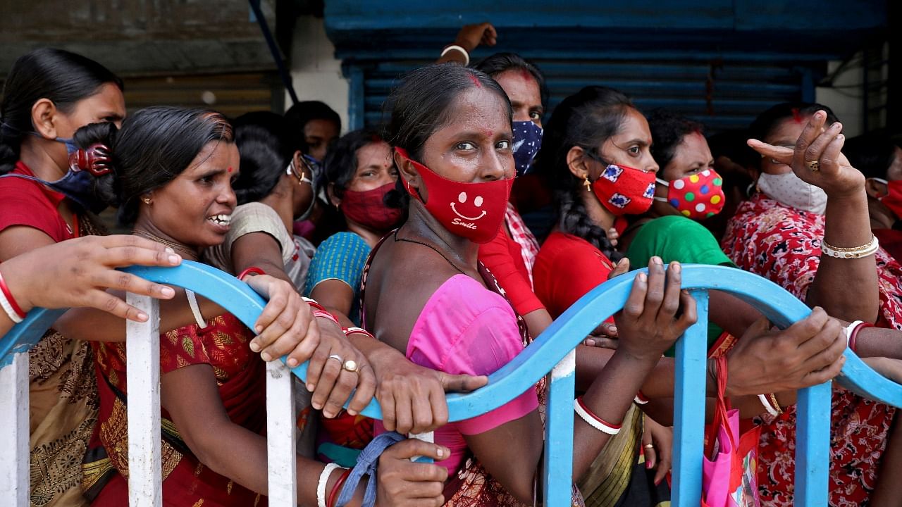 Women wait to receive a dose of Covishield vaccine in Kolkata. Credit: Reuters File Photo