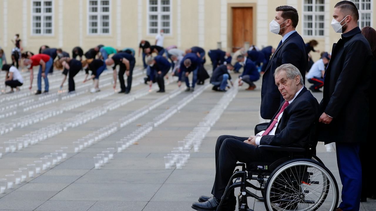 Czech President Milos Zeman watches as employees of Prague Castle light candles to commemorate the victims of the coronavirus. Credit: Reuters File Photo