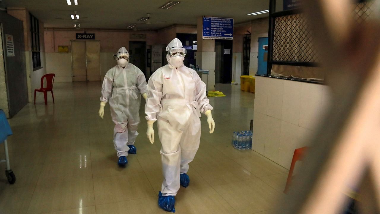 Health officials in full protective gear walk inside an isolation ward of Ernakulam Medical College in Kochi. Credit: AFP Photo