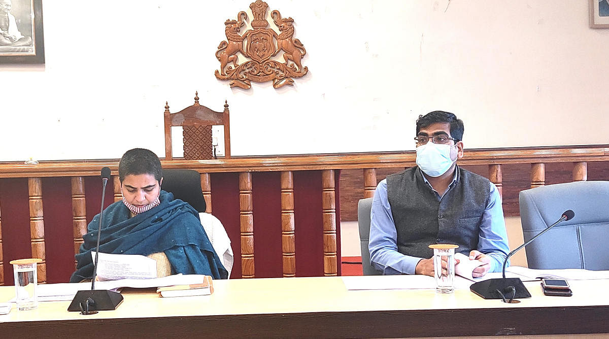 Deputy Commissioner Charulata Somal chairs the SCP-TSP review meeting in Madikeri on Monday. ZP CEO Bhanwar Singh Meena looks on. DH Photo