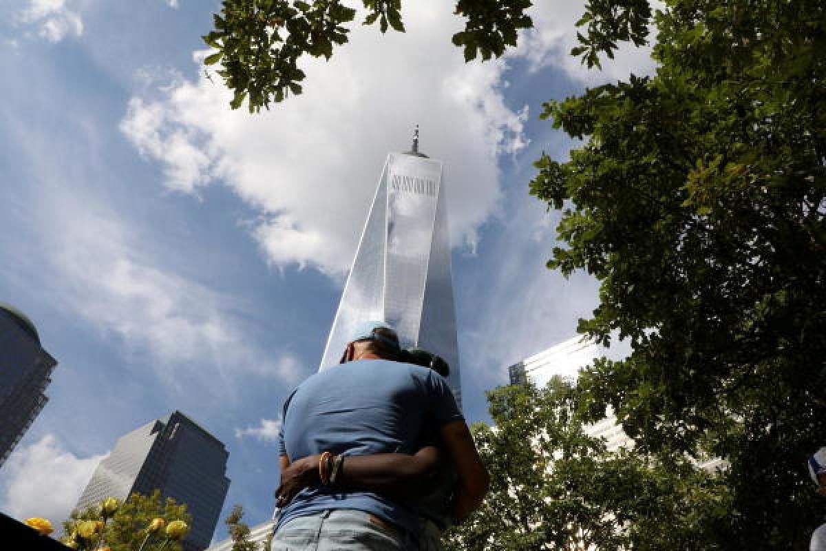 People embraced each other in front of 9/11 Memorial on the 20th anniversary of the September 11, 2001 attacks in New York City.