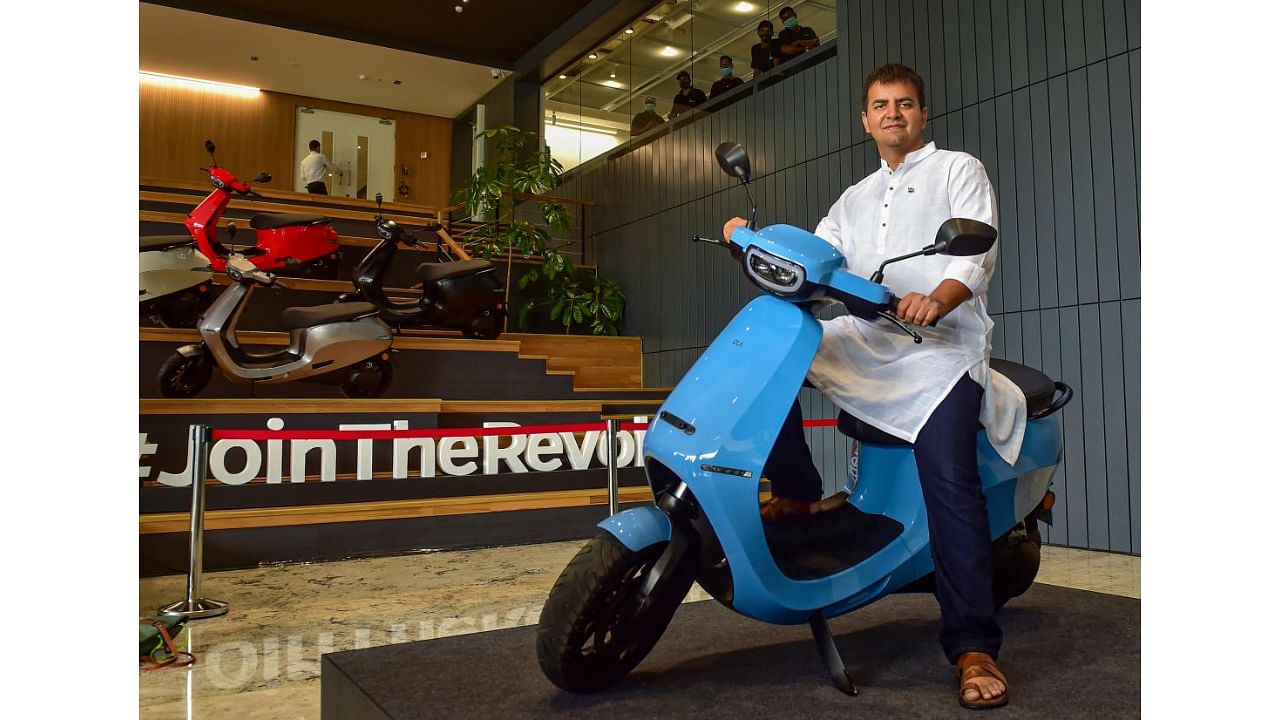 Ola CEO Bhavish Aggarwal poses with Ola E-Scooter. Credit: PTI File Photo