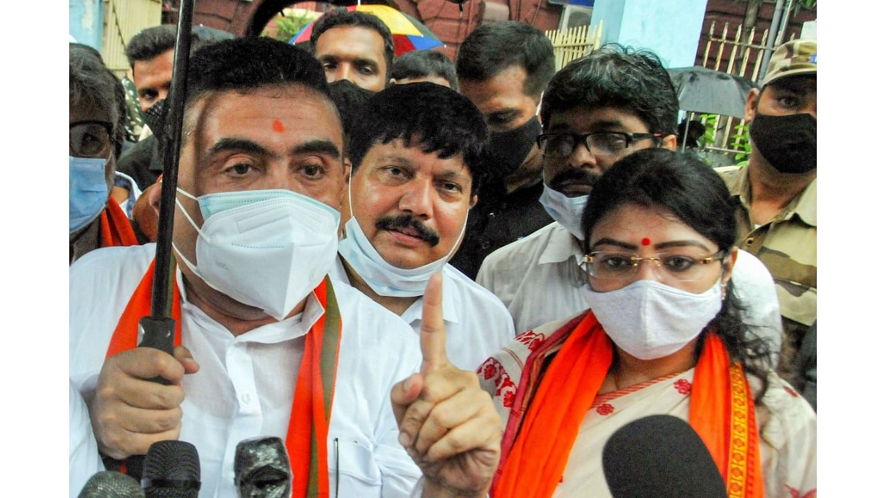 BJP candidate for Bhabanipur constituency Priyanka Tibrewal with West Bengal Assembly Opposition leader Suvendu Adhikari (L) and MP Arjun Singh (C), leaves after filing her nomination for the State By-elections, in Kolkata, Monday, September 13, 2021. Credit: PTI Photo