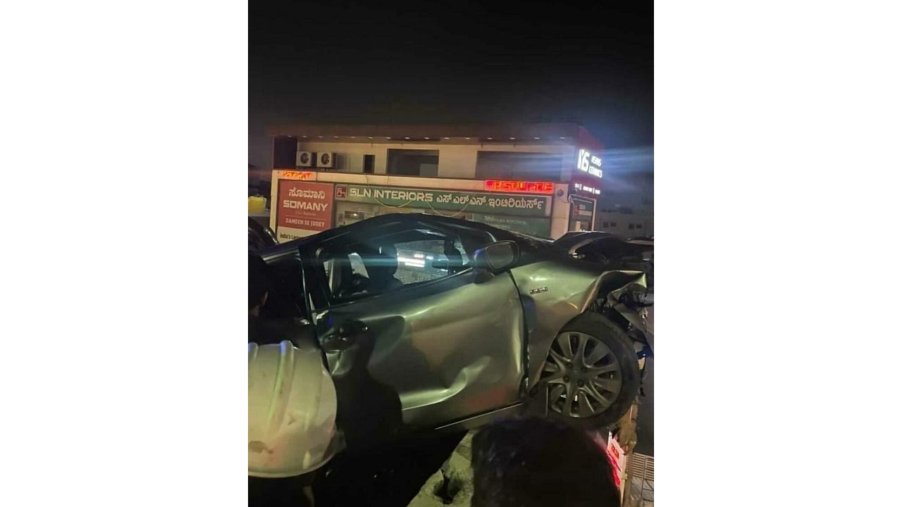 The car that hit the motorcycle and crashed into the side wall of the flyover on Hosur Road. Credit: DH Photo