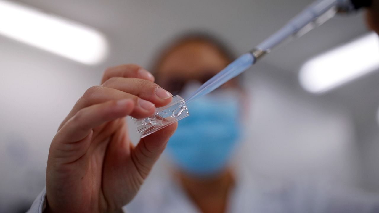 A researcher manipulates proteins in a laboratory as part of a project to develop a Covid nasal spray vaccine that could protect against the coronavirus disease. Credit: Reuters Photo