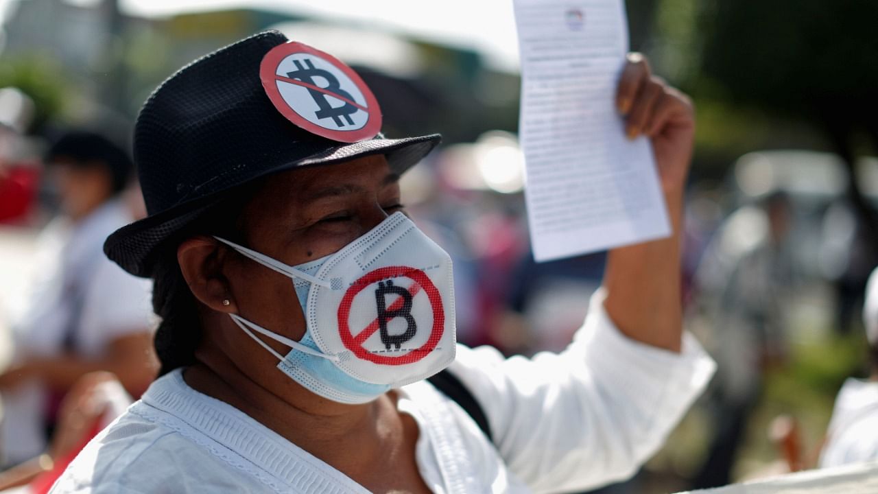 A masked protester takes part in a protest against the use of Bitcoin as legal tender and legal reforms to extend president Nayib Bukele's term in San Salvador, El Salvador. Credit: Reuters Photo