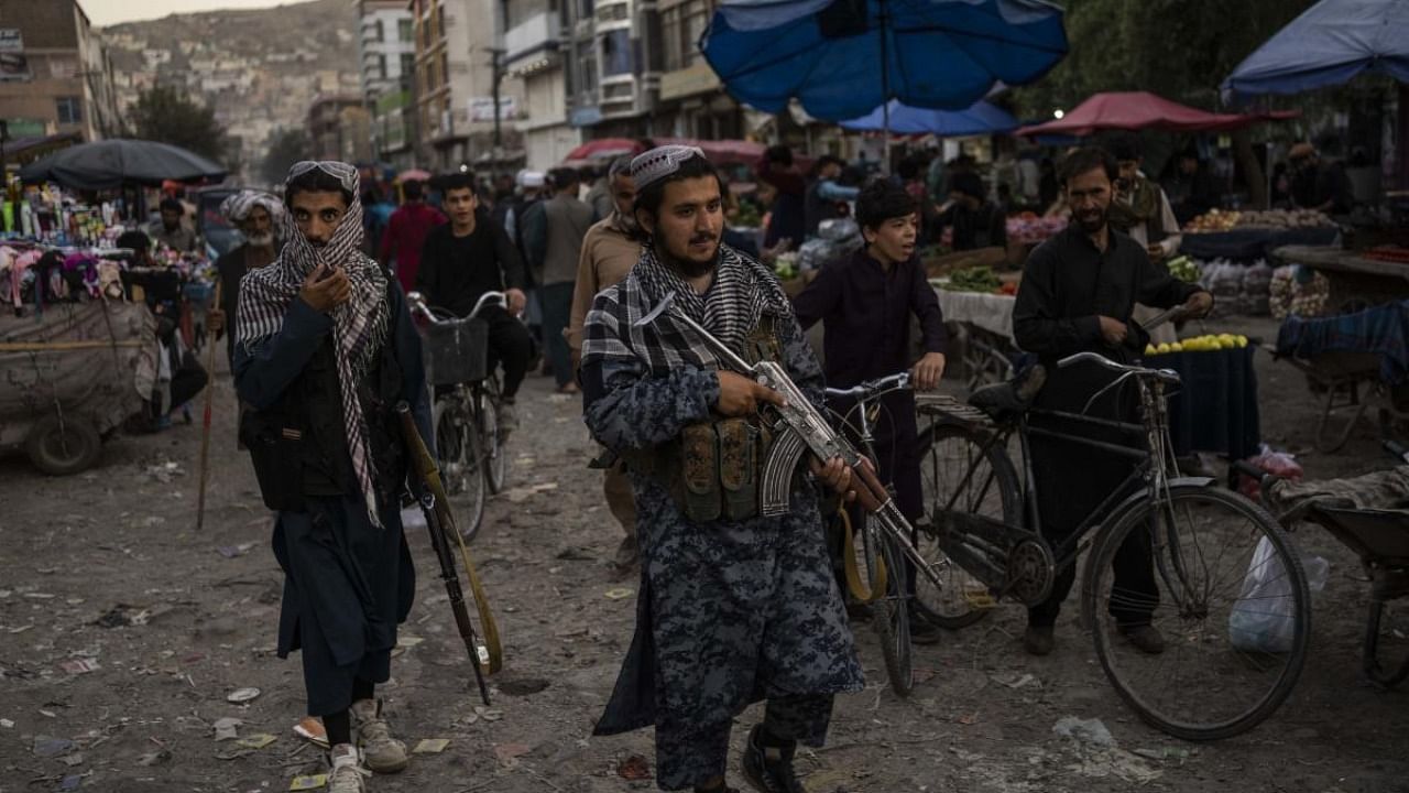 Taliban fighters patrol a market in Kabul's Old City, Afghanistan. Credit: AP Photo