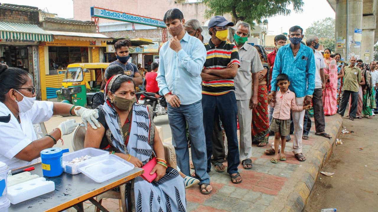 Health workers inoculate a Covid-19 vaccine dose to a beneficiary during a mega-vaccination drive to mark PM Modi's 71st birthday, in Ahmedabad. Credit: PTI Photo