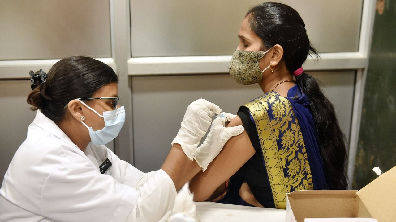 A medic administers Covid-19 vaccine dose to a woman, at Civil Hospital in Lucknow. Credit: PTI Photo