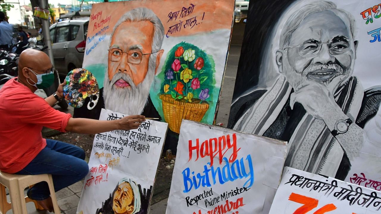 Artists make paintings of PM Narendra Modi to wish him on his birthday, at Lalbaug, in Mumbai, Thursday. Credit: PTI Photo