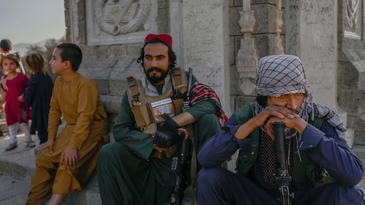 Taliban fighters (L) keep watch at the Kabul zoo on September 17, 2021. Credit: AFP Photo