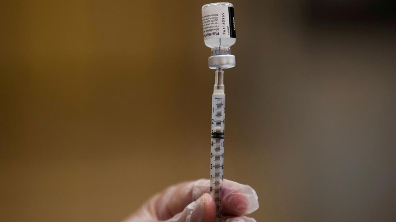  A nurse fills a syringe with Pfizer vaccine. Credit: Reuters Photo