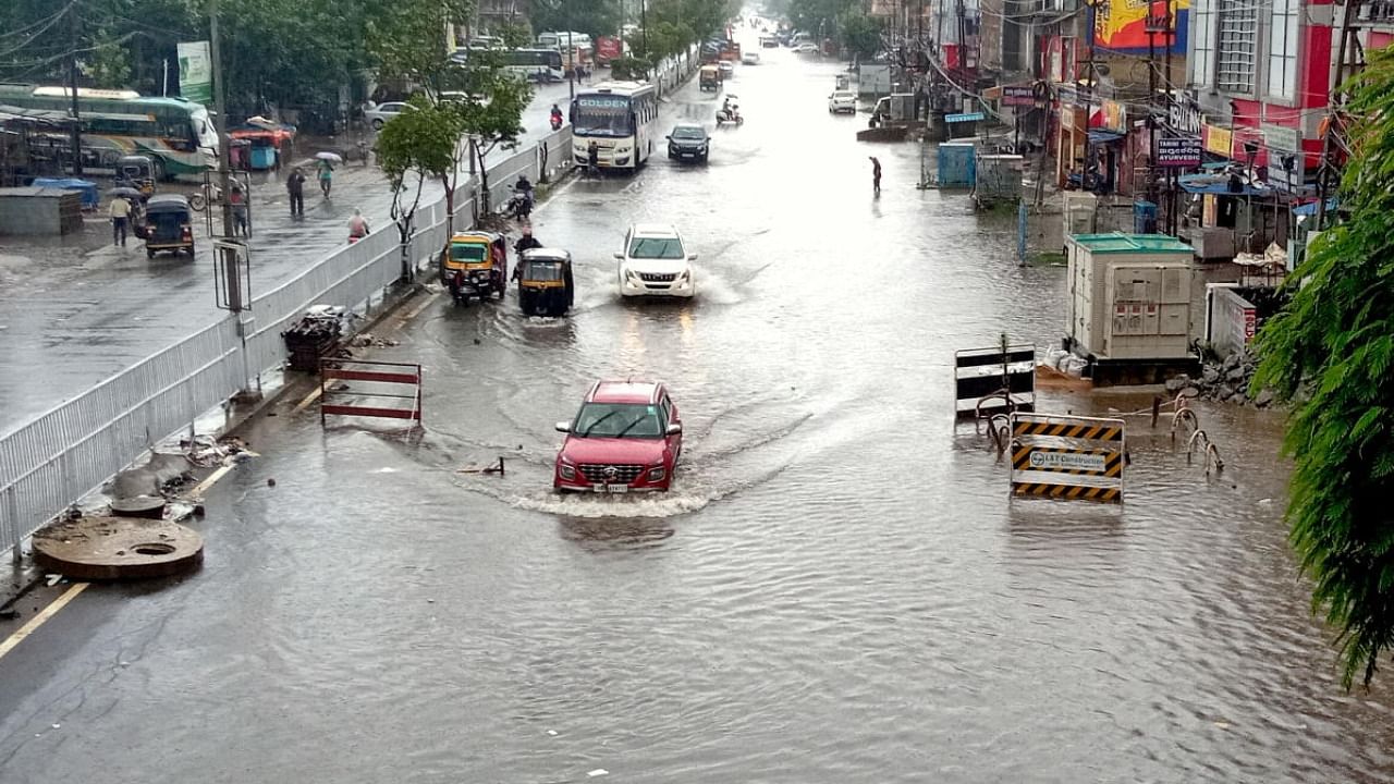 Vehicles wade through a waterlogged street following heavy rains in Cuttack. Credit: PTI Photo