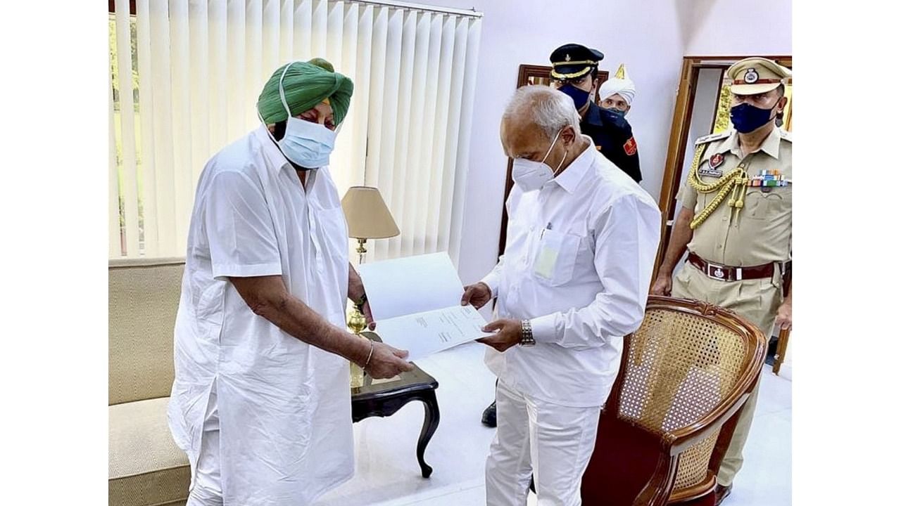 Punjab Chief Minister Capt. Amrinder Singh submits his resignation to Governor Banwarilal Purohit at the Raj Bhavan in Chandigarh, Saturday. Credit: PTI Photo