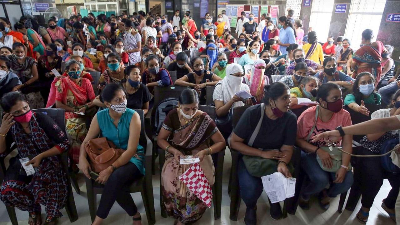 Women beneficiaries wait to receive Covid-19 vaccine shots during a special Covid-19 vaccination drive organised for women by the Brihanmumbai Municipal Corporation (BMC), in Mumbai. Credit: PTI file photo