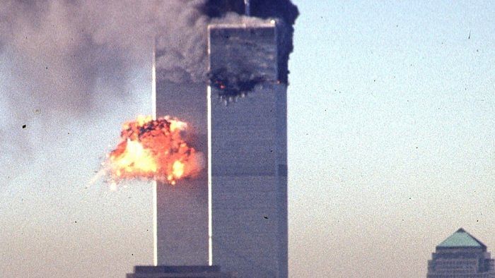 Smoke and flames erupt from the twin towers of the World Trade Center, after commercial aircraft were deliberately crashed into the buildings. Credit: AFP File photo