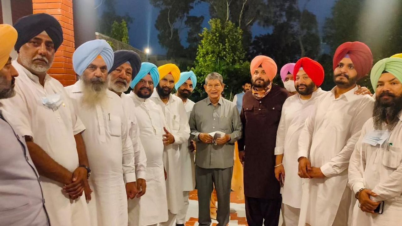  Punjab CM Designate Charanjit Singh Channi with Punjab Congress President Navjot Sidhu and senior party leader Harish Rawat after submitting the letter to Punjab Governor Banwarilal Purohit (unseen), in Chandigarh, Sunday, Sept. 19, 2021. Credit: PTI Photo