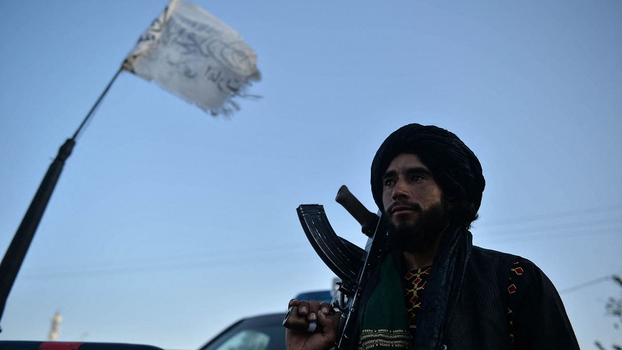 A Taliban fighter stands along a road in Herat on September 19, 2021. Credit: AFP Photo