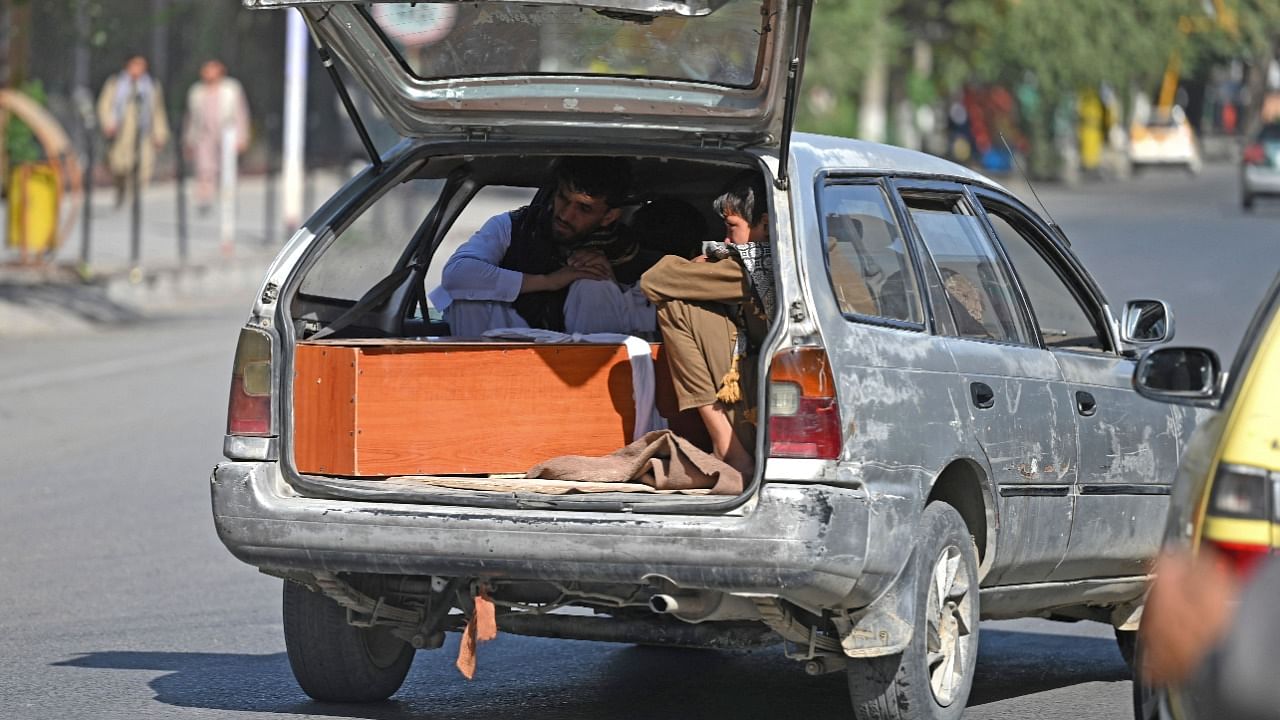 Relatives transport in a car the coffin of victim of the August 26 twin suicide bombs, which killed scores of people including 13 US troops outside Kabul airport, in Kabul on August 27, 2021. Credit: AFP Photo