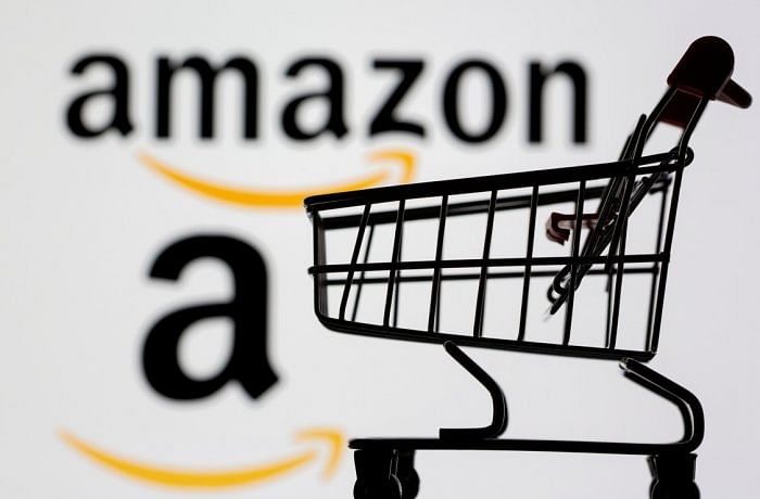 Small toy shopping cart is seen in front of displayed Amazon logo. Credit: Reuters File Photo