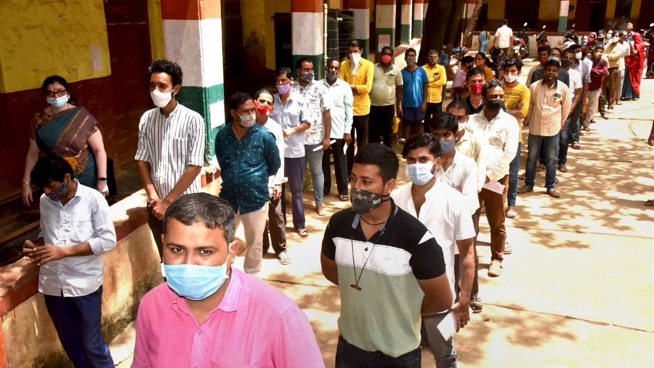 Beneficiaries wait in queues to receive Covid-19 vaccine dose, in Hubballi. Credit: PTI File Photo