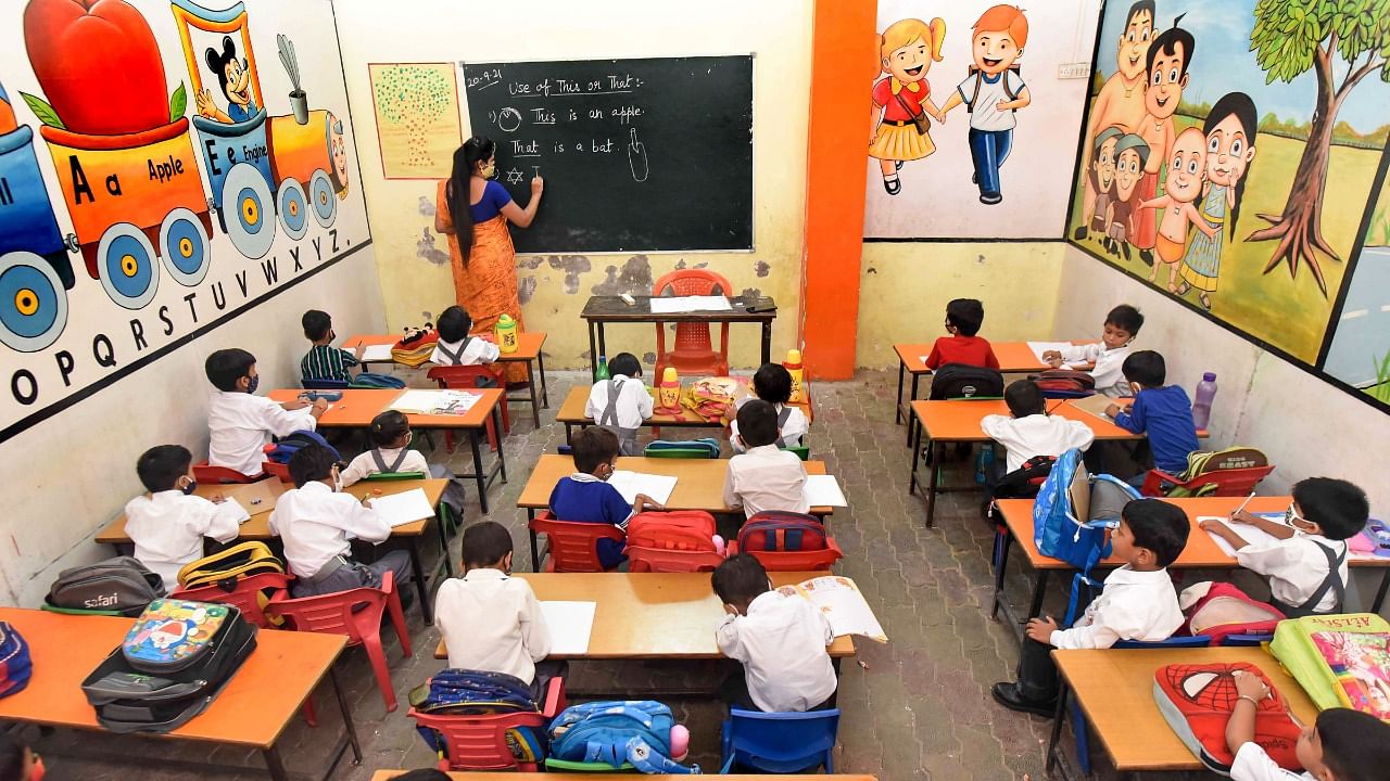 Students attend a class at a government school in Prayagraj, Monday, September 20, 2021. Credit: PTI Photo