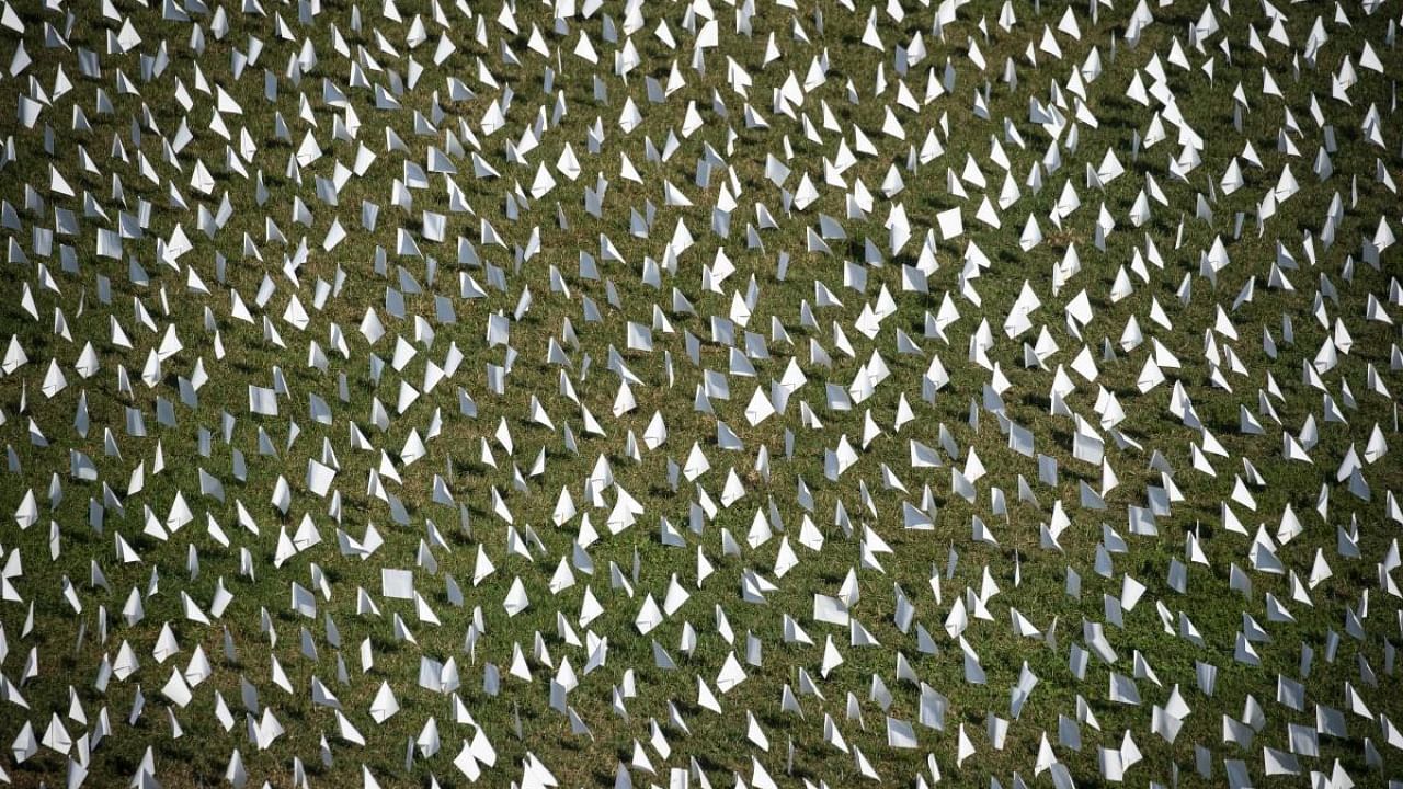 In this elevated view, flags fly at the 'In America: Remember' public art installation near the Washington Monument on September 19, 2021 in Washington, DC. Credit: AFP Photo