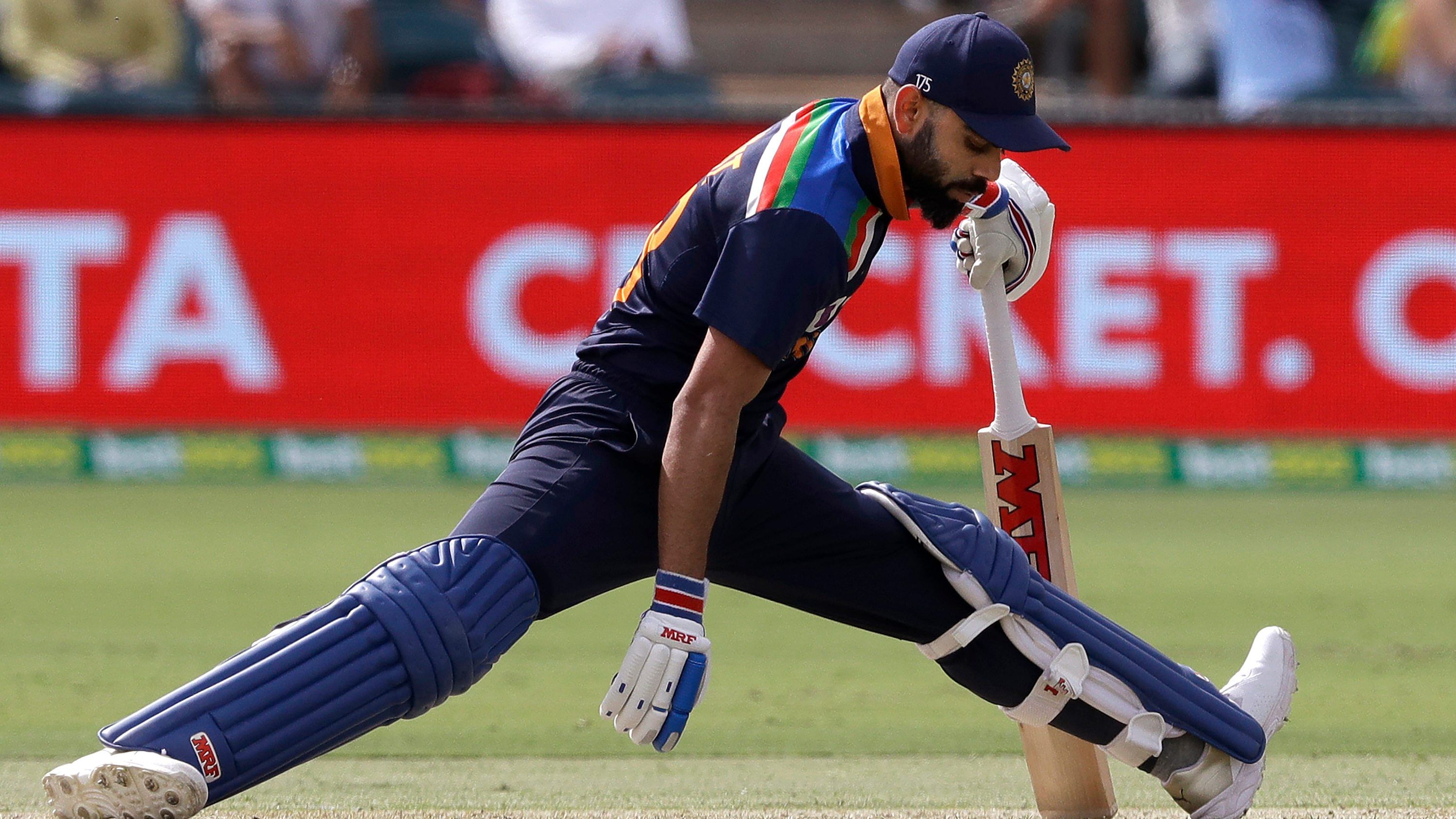Virat Kohli stretches his legs while batting against Australia during their one day international cricket match at Manuka Oval in Canberra. Credit: AP File Photo