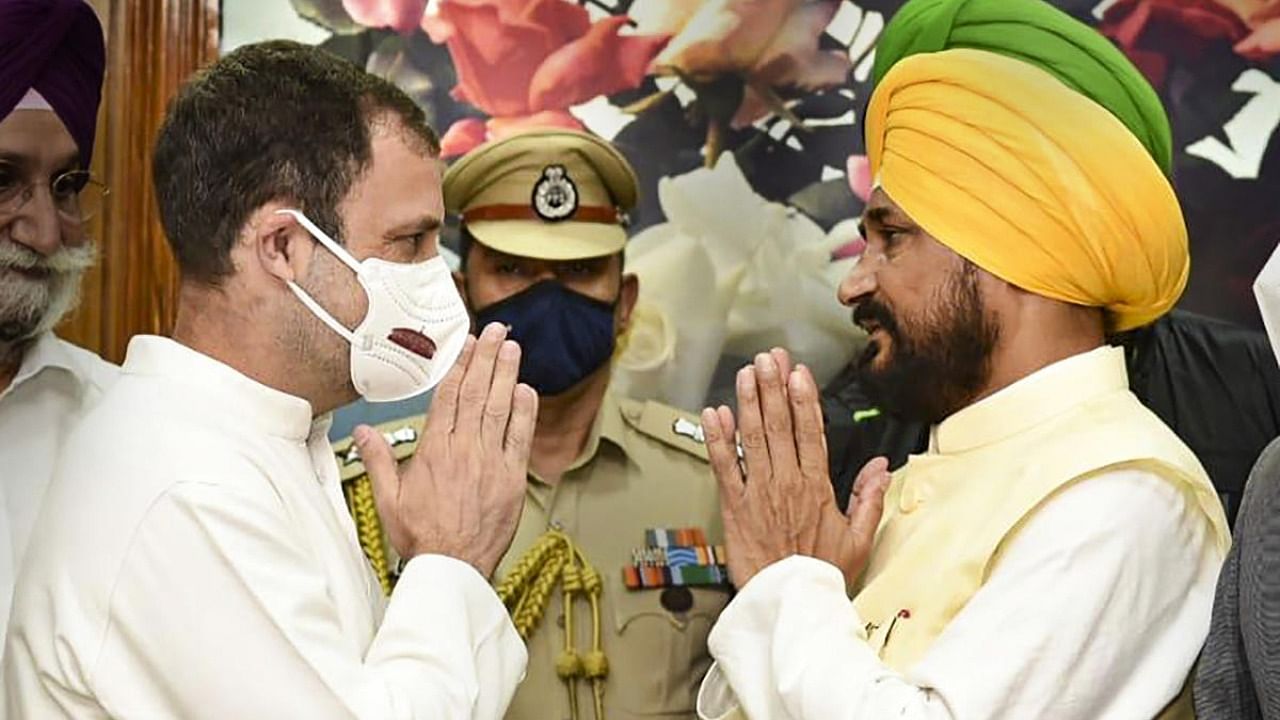Congress MP Rahul Gandhi greets new Punjab Chief Minister Charanjit Singh Channi after the latter takes the oath of office during a ceremony, at Raj Bhawan in Chandigarh. Credit: PTI Photo