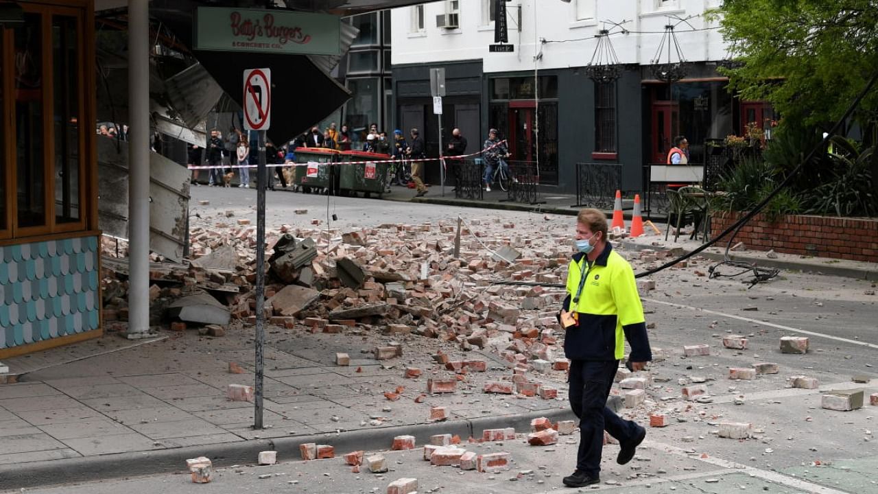 A person walks past damage to the exterior of a restaurant following an earthquake in the Windsor suburb of Melbourne, Australia. Credit: Reuters Photo