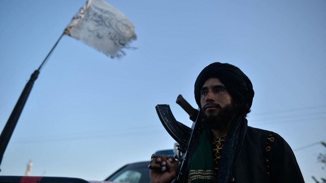 A Taliban fighter stands along a road in Herat. Credit: AFP File Photo