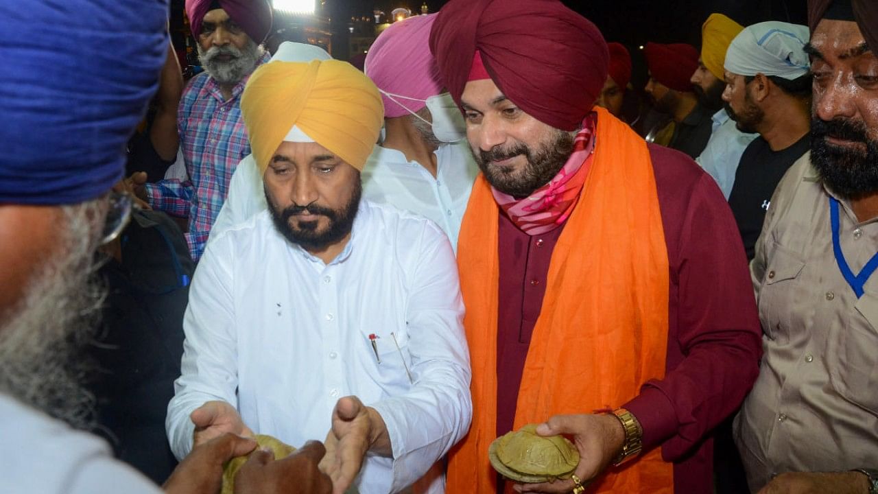 Punjab Chief Minister Charanjit Singh Channi along with PPCC President Navjot Singh Sidhu (R) pay obeisance at Golden Temple in Amritsar. Credit: PTI Photo