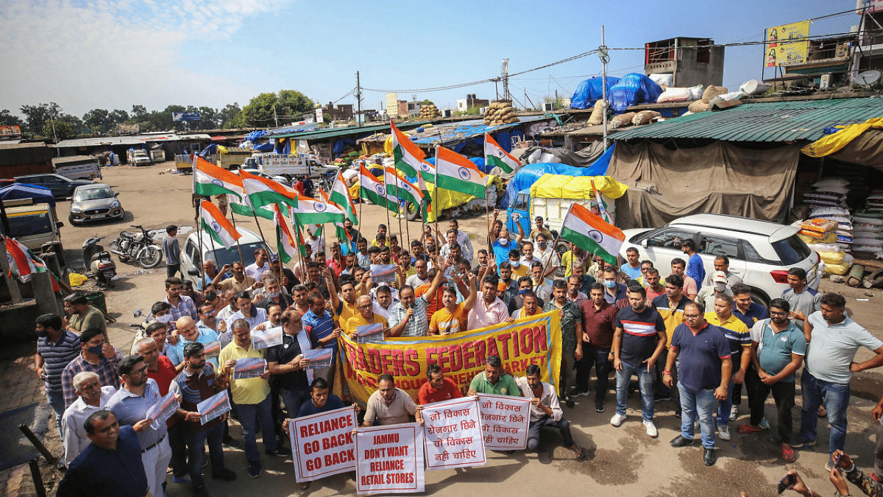 Members of Traders Federation stage a protest during their Jammu Bandh call against the opening of more new showrooms and retailer shops of Reliance Mart, in Jammu. Credit: PTI Photo
