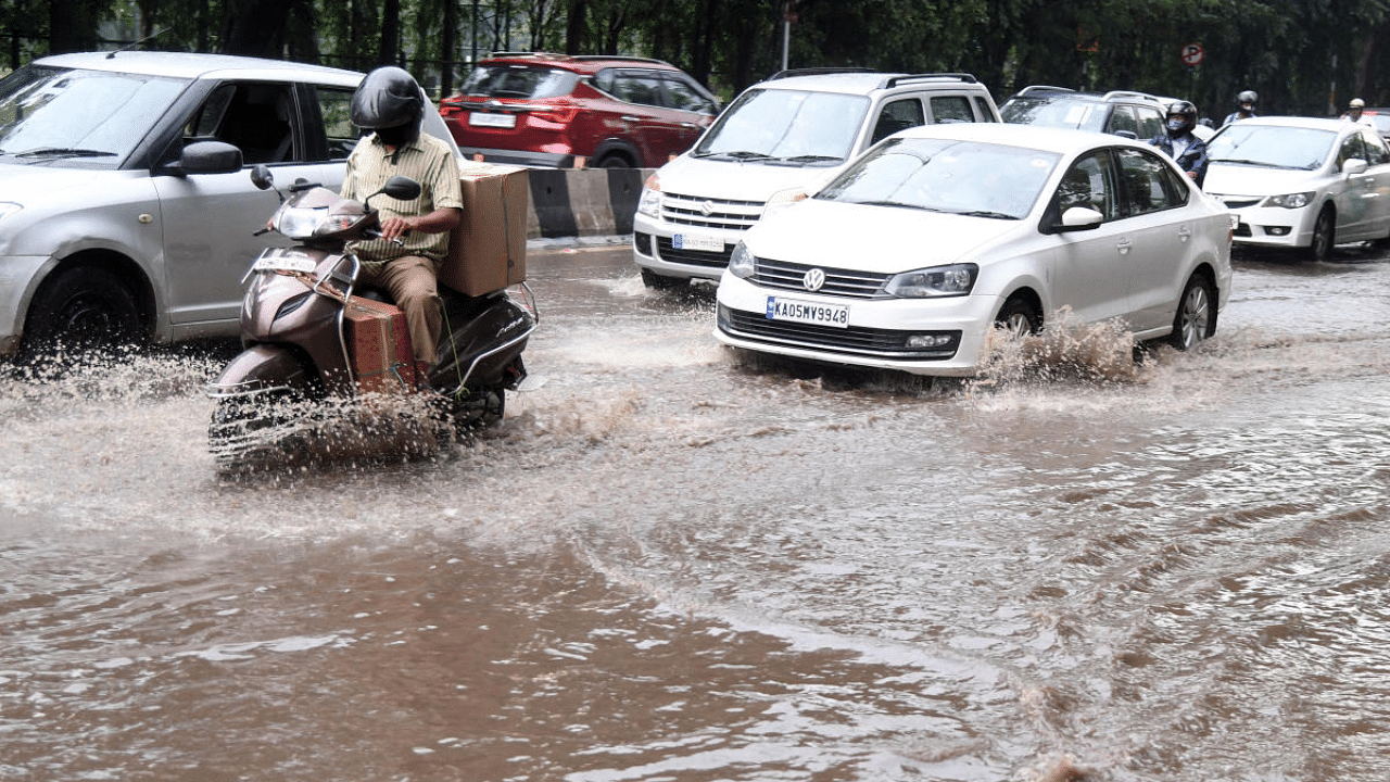Motorists make their way through a waterlogged Sankey road, following heavy rains in Bengaluru. Credit: DH File Photo