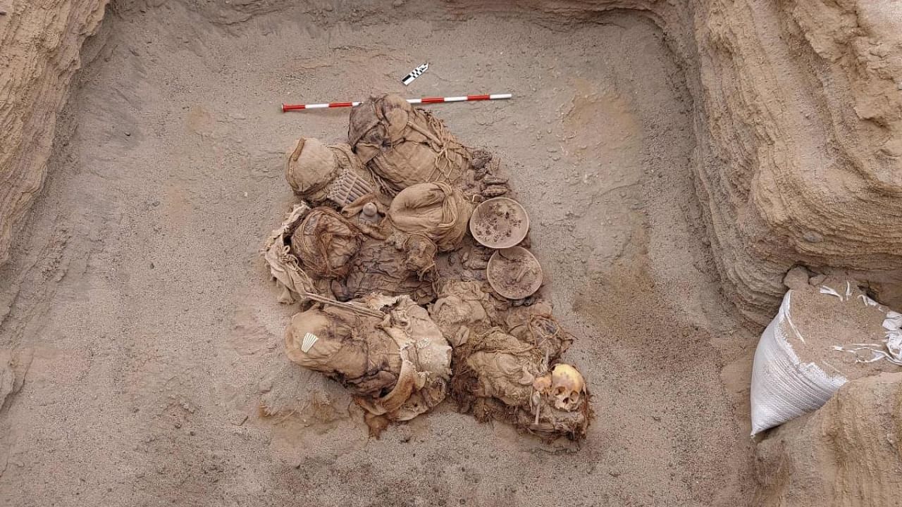 Handout picture released by Peruvian gas company Calidda, shows objects, food, artifacts and ancient funeral bundles containing the remains of 8 inhabitants who where uncovered by workers of the gas distributing company Calidda, during the installation of natural gas pipes in a neighborhood in the town of Chilca. Credit: AFP Photo/Calidda/Jesus Bahamonde