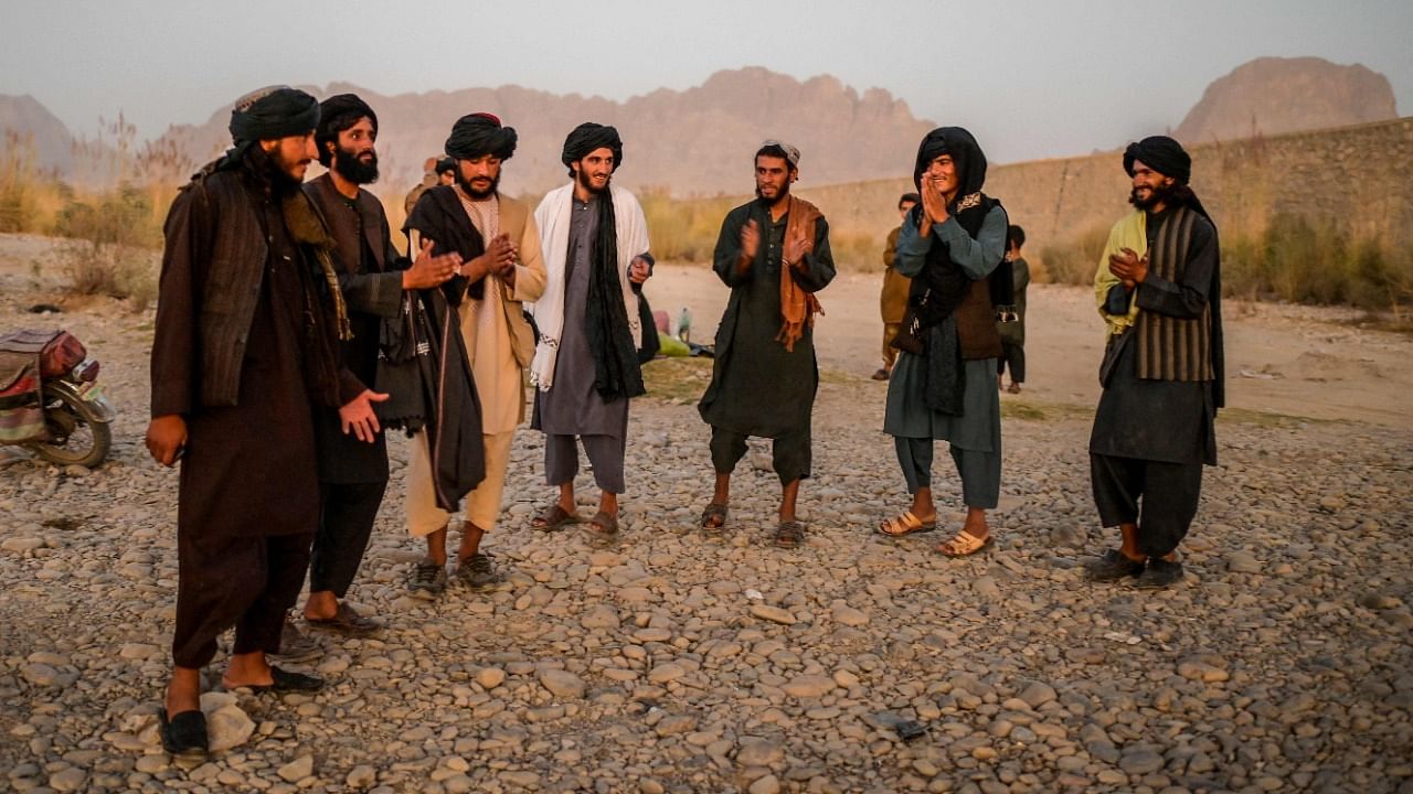 Taliban members enjoy a traditional dance on the banks of a river in Kandahar. Credit: AFP Photo