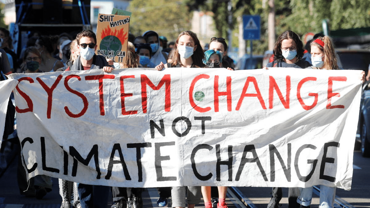 Climate activists of Klimastreik Schweiz hold a banner during a protest in Zurich, Switzerland. Credit: Reuters Photo