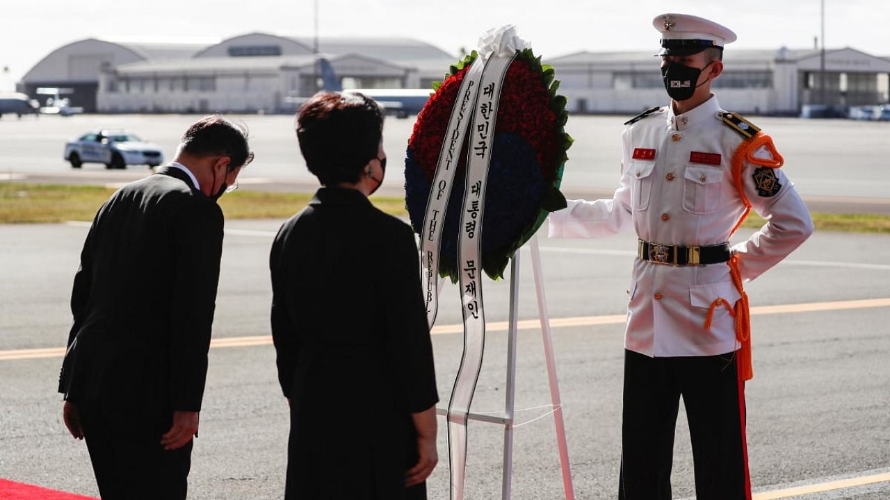 South Korea's President Moon Jae-in and First Lady Kim Jung-sook bow at a wreath during the first joint repatriation ceremony for Korean War remains at Joint Base Pearl Harbor-Hickam near Honolulu, Hawaii, US. Credit: Reuters photo