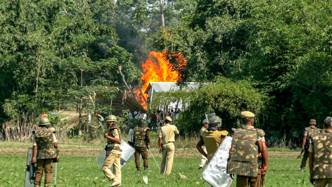 Cops disperse people protesting against the eviction drive in Darrang district. Credit: PTI Photo