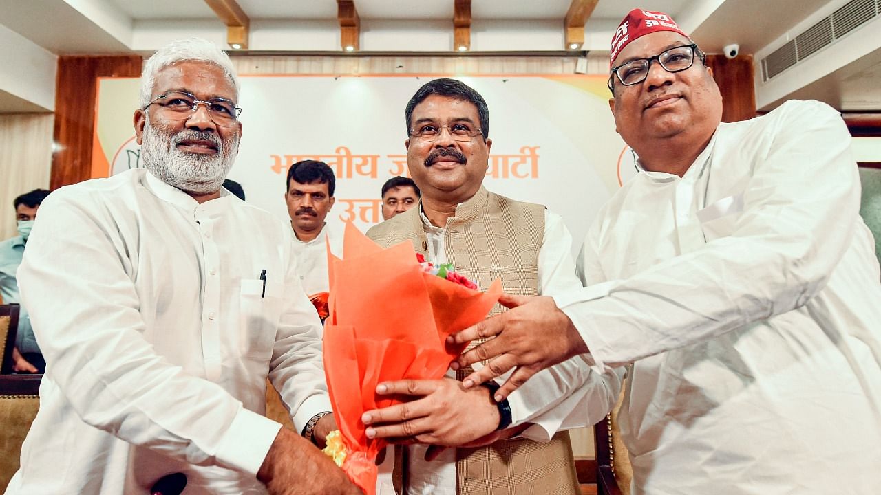 Union Minister and BJP's UP election incharge Dharmendra Pradhan being welcomed by UP BJP President Swatantra Dev Singh (L) and Nishad Party President Sanjai Nishad (R). Credit: PTI Photo