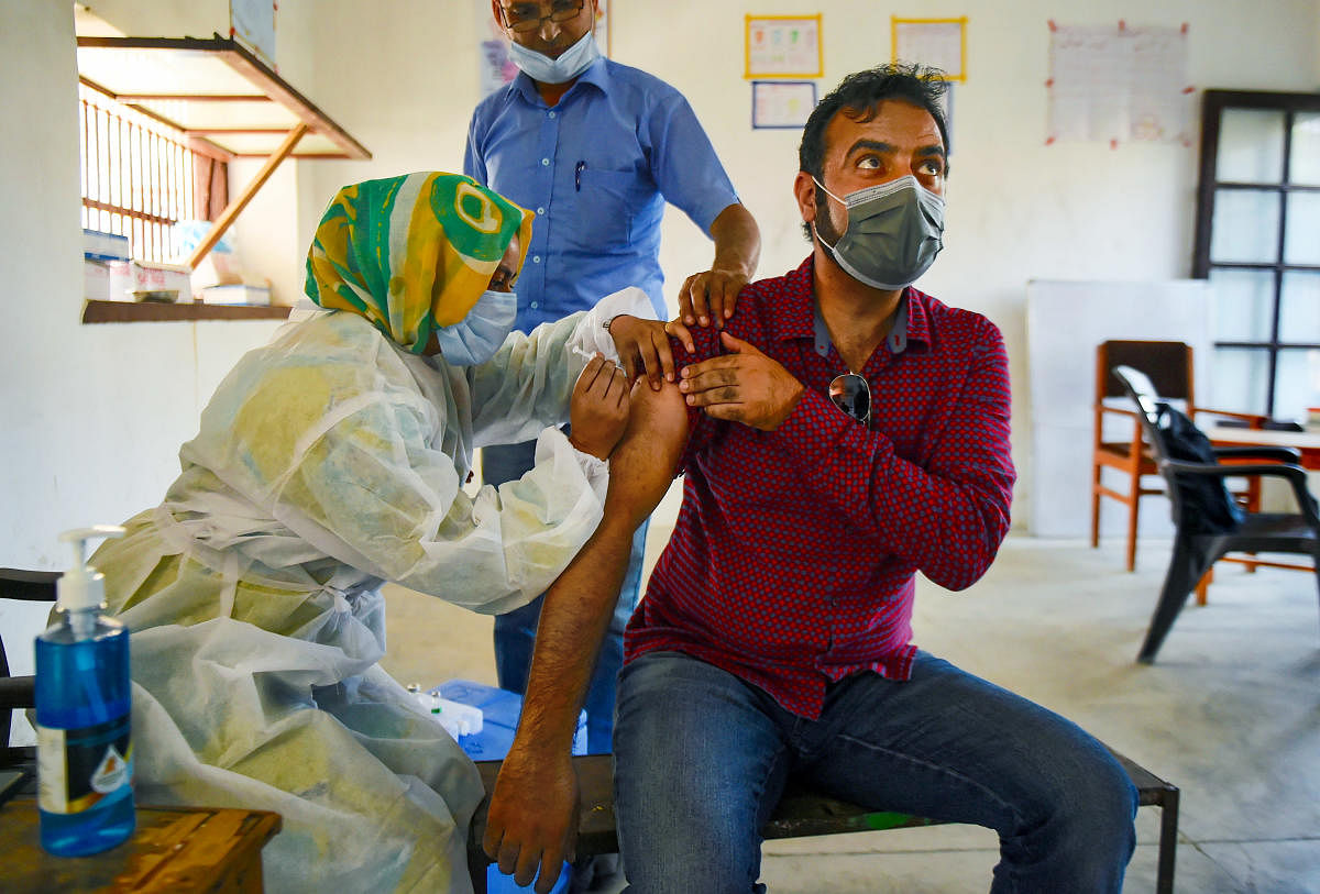 A medic administers a dose of Covid-19 vaccine to a beneficiary in Srinagar. Credit: PTI Photo