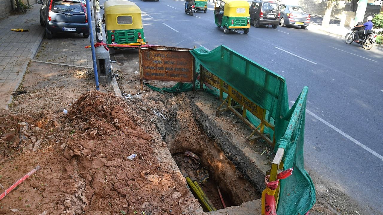 KPTCL dig the road at various spots on the TenderSure Residency Road to lay underground cables. Credit: DH Photo