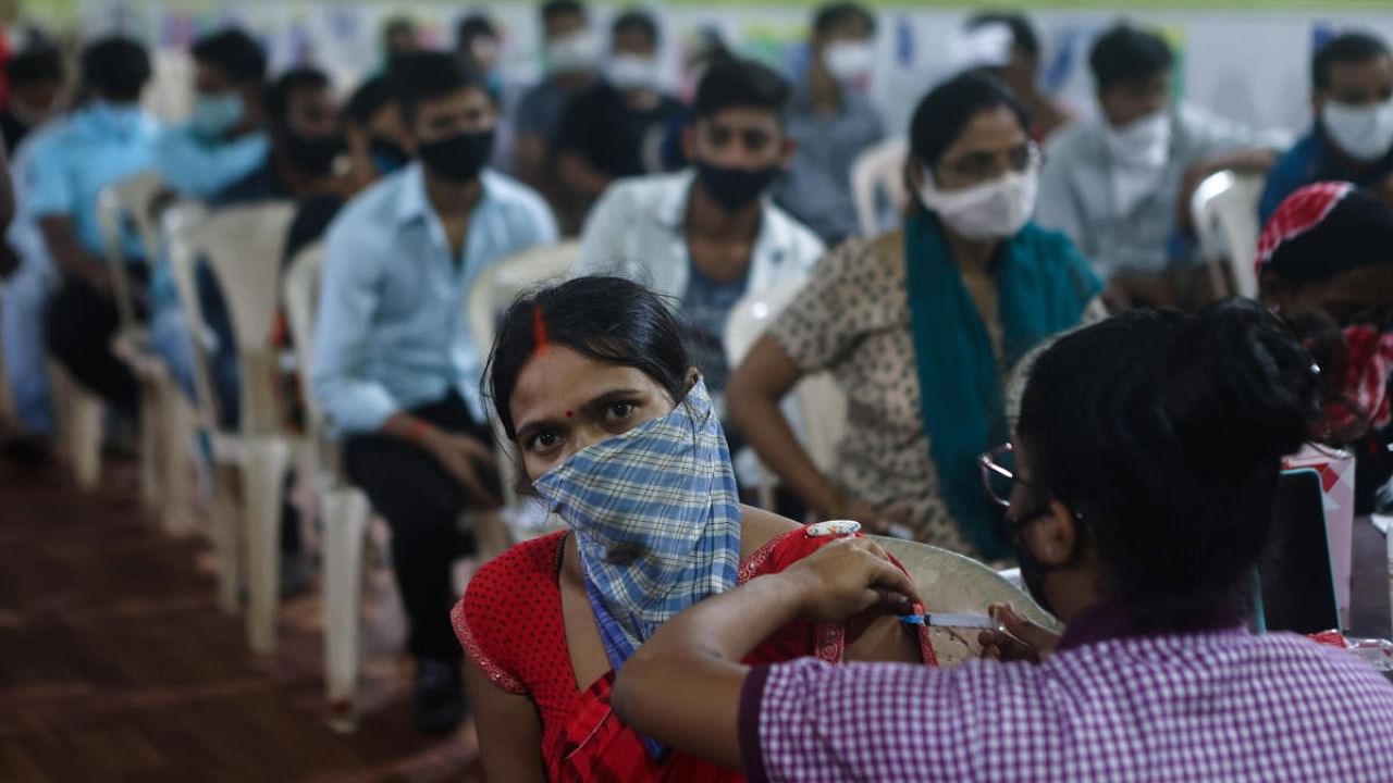 Healtthcare workers administer a dose of Covid-19 vaccine in Mumbai. Credit: Reuters Photo