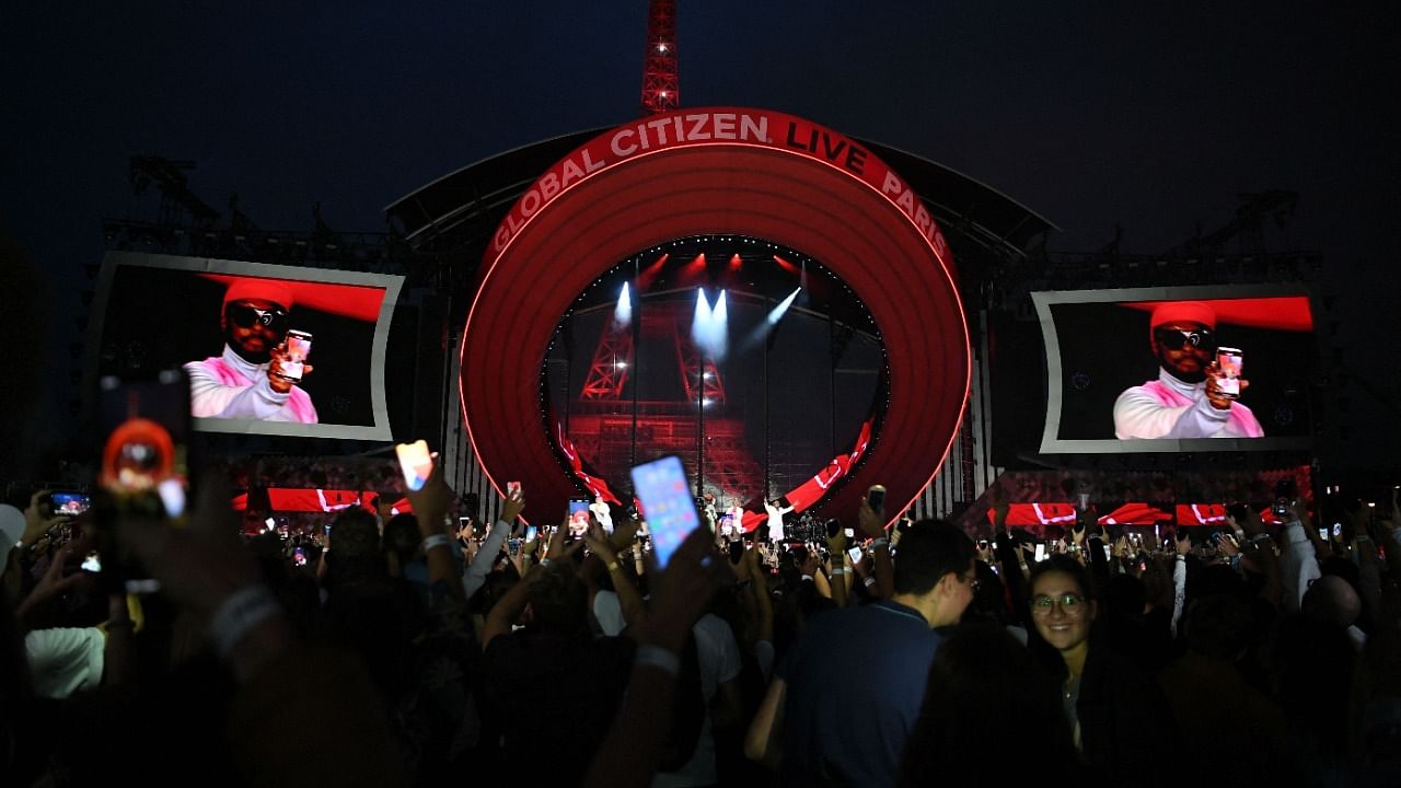 Attendees enjoy a 'Global Citizen Live' concert in Paris on September 25, 2021. Credit: AFP Photo
