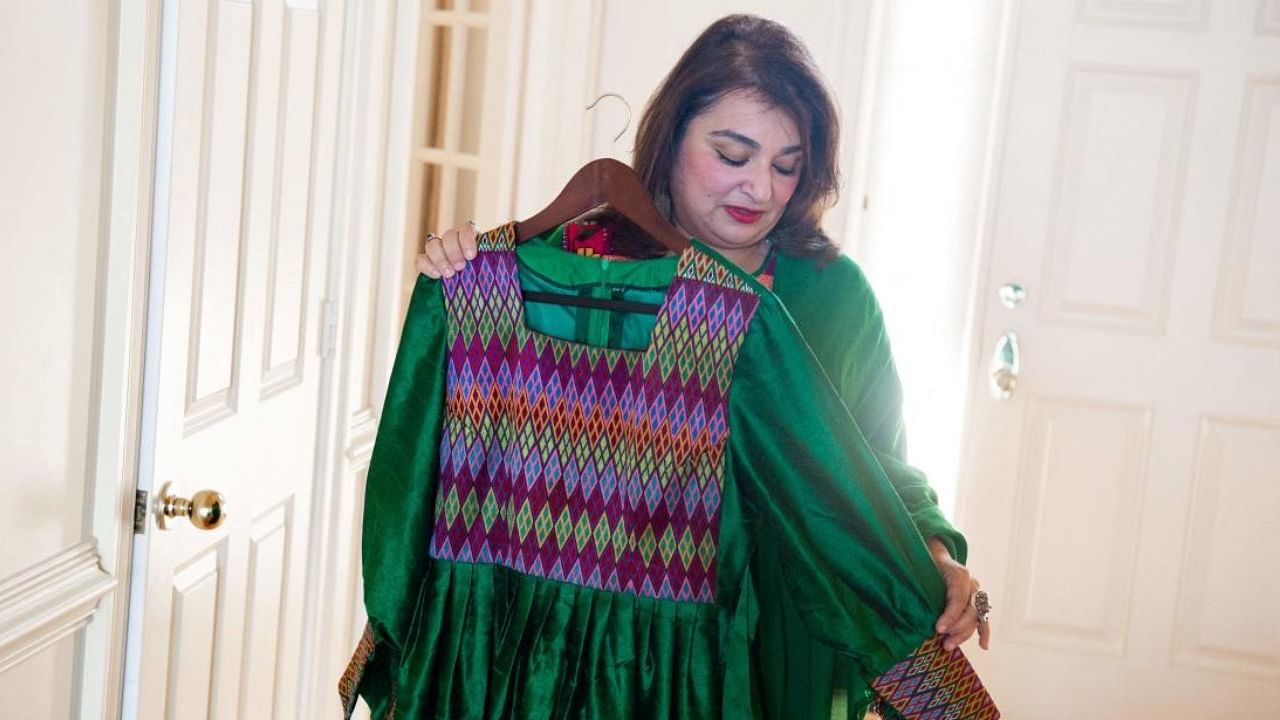 Bahar Jalali, an Afghan academic, shows an Afghan traditional dress. Credit: AFP Photo
