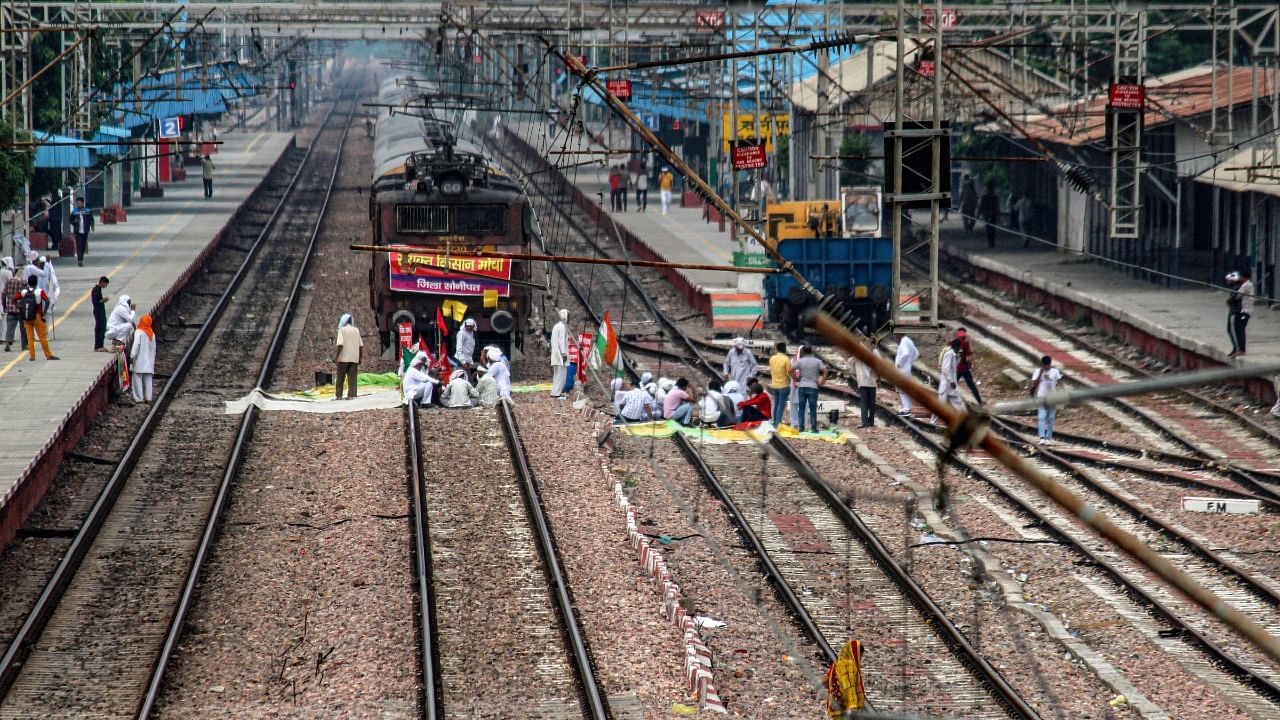 Farmers block railway tracks as part of protests against farm reforms during 'Bharat Bandh.' Credit: PTI Photo