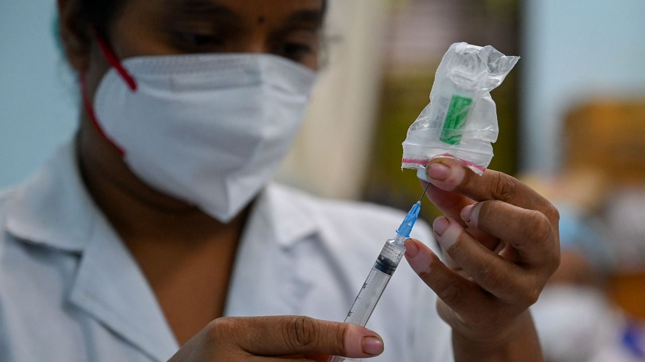 A health worker prepares a dose of the Covishield Covid-19 vaccine. Credit: AFP Photo