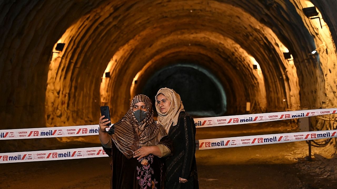 Plain clothes police women take selfies at the Zojila tunnel which connects Srinagar to Ladakh. Credit: AFP Photo