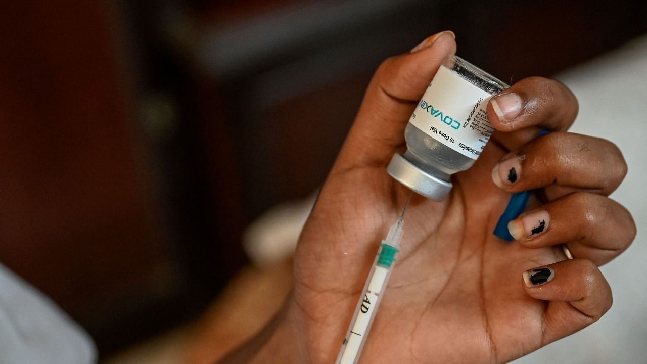 A health worker prepares a dose of Covaxin Covid-19 vaccine. Credit: AFP File Photo