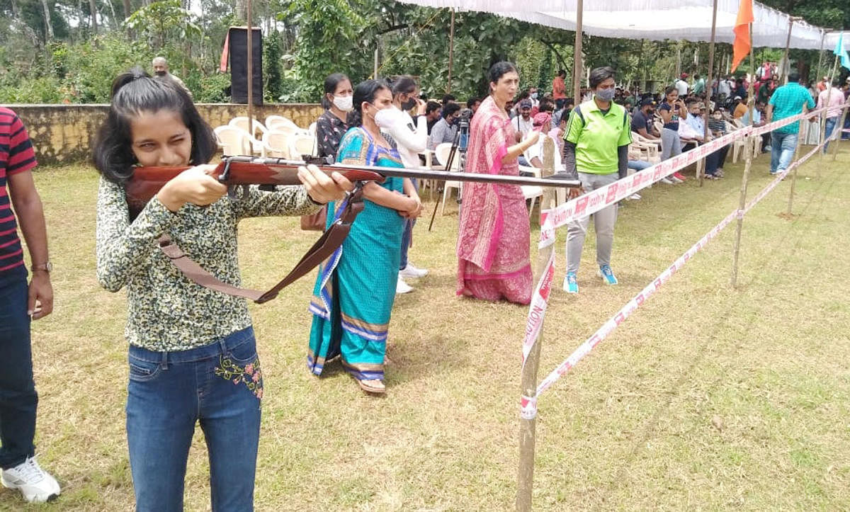 Women and young girls take part in a coconut shooting competition in Mayamudi.
